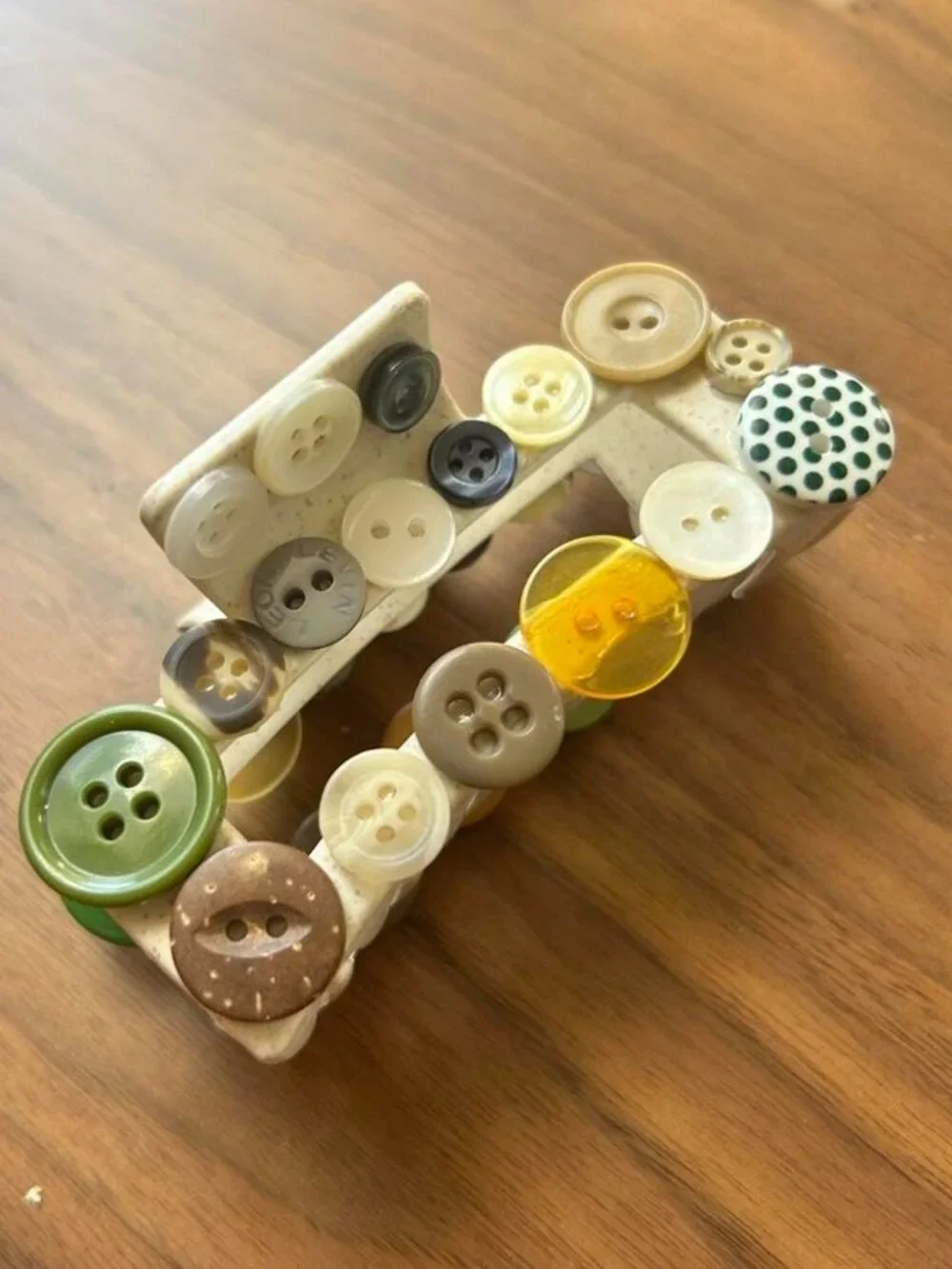Multi-colored button hair clip with assorted buttons in various sizes and colors